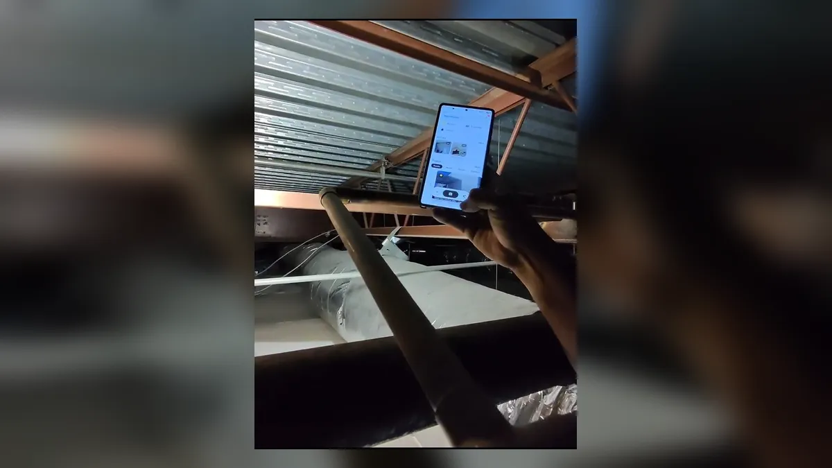 contractor uses a tablet to document overhead commercial plumbing for Maricopa Plumbing Pros