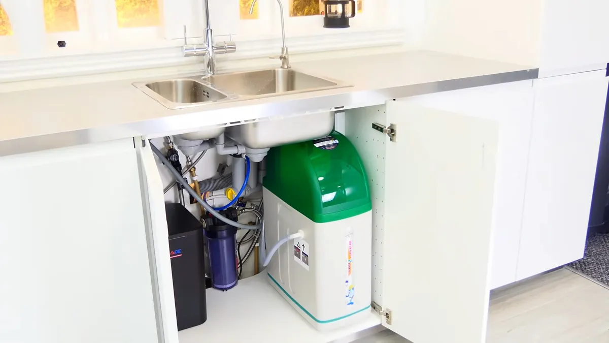 compact green treatment tank and filter cartridges fit beneath a kitchen sink for Maricopa Plumbing Pros