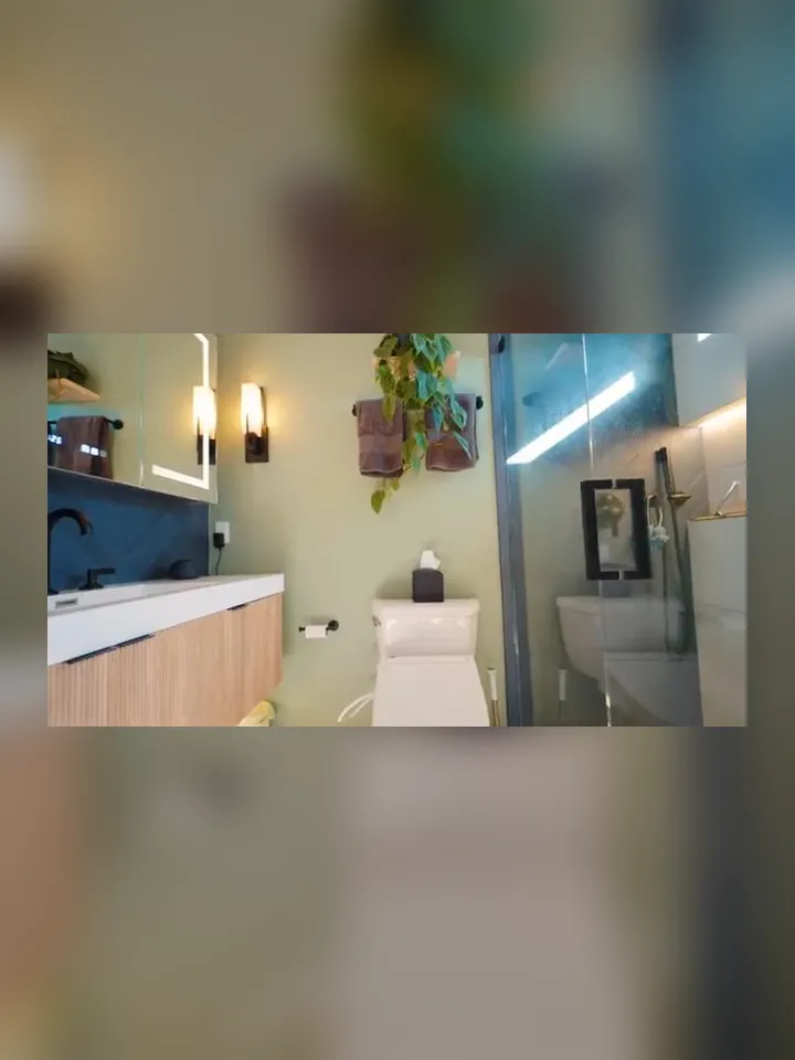 renovated bathroom combines a modern vanity, toilet, mirror, and glass shower for Maricopa Plumbing Pros